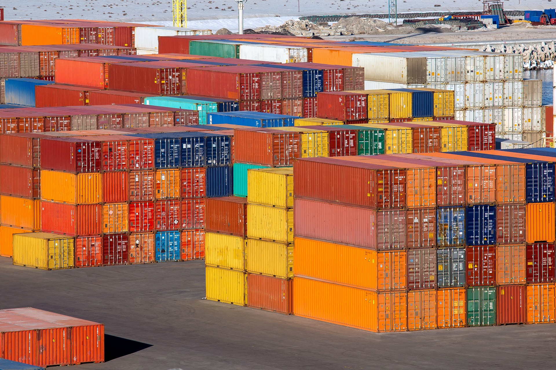 port warehouse of a container terminal with export cargo stockpiled at customs control stacks of multi-colored iron containers brokerage services, nobody.